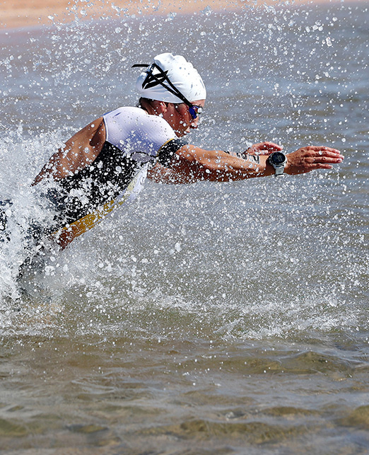 An athlete swimming in NEOM as part of the triathlon series