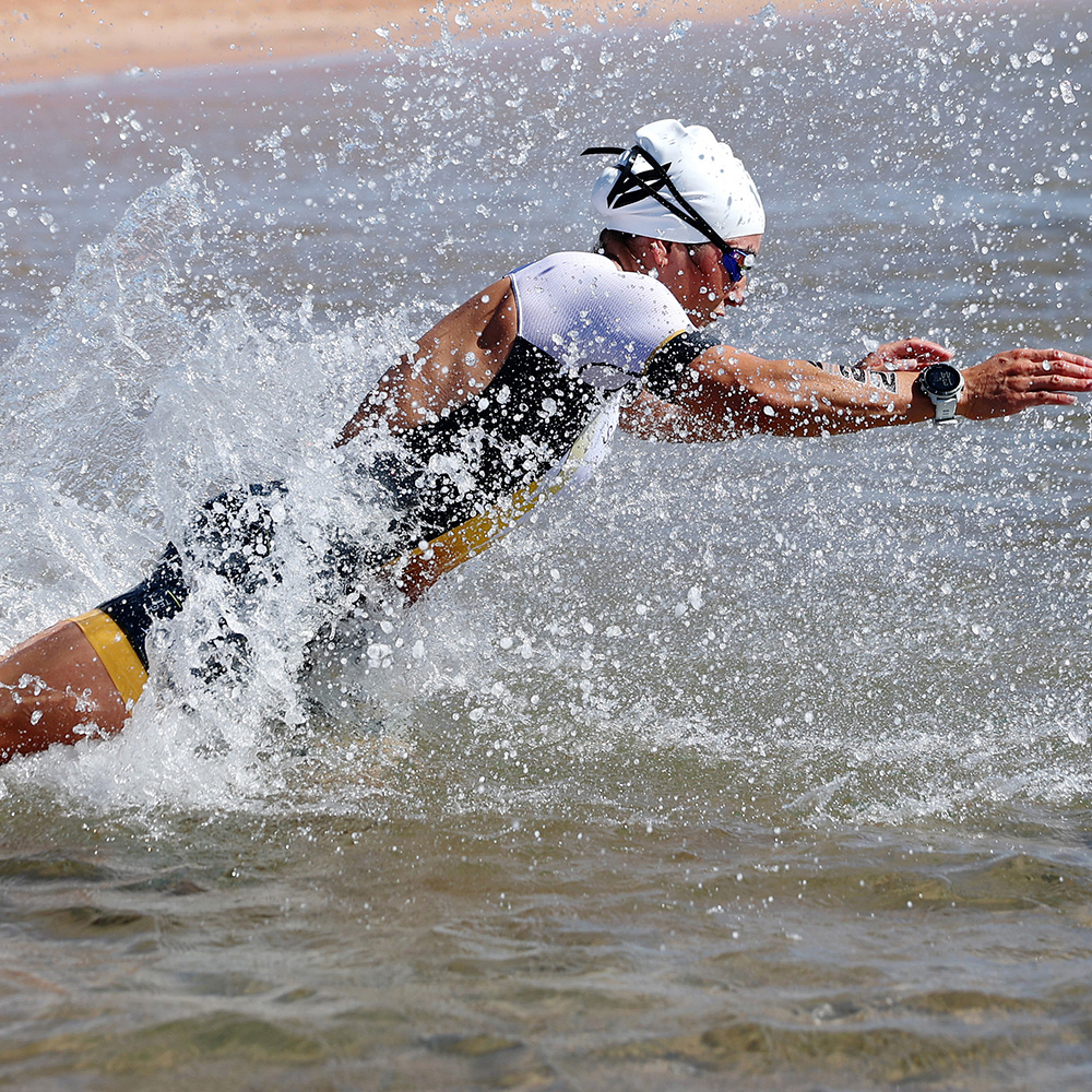 Triathlon race with cyclists, runners, and swimmers in NEOM